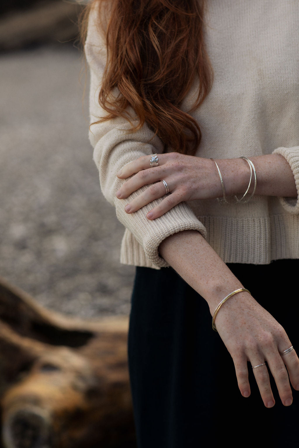 Lady in jumper wearing rings and bangles