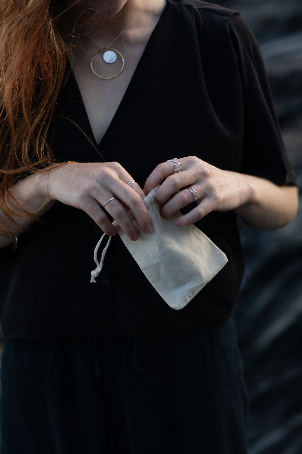 Person holding a small white bag with a blurred background