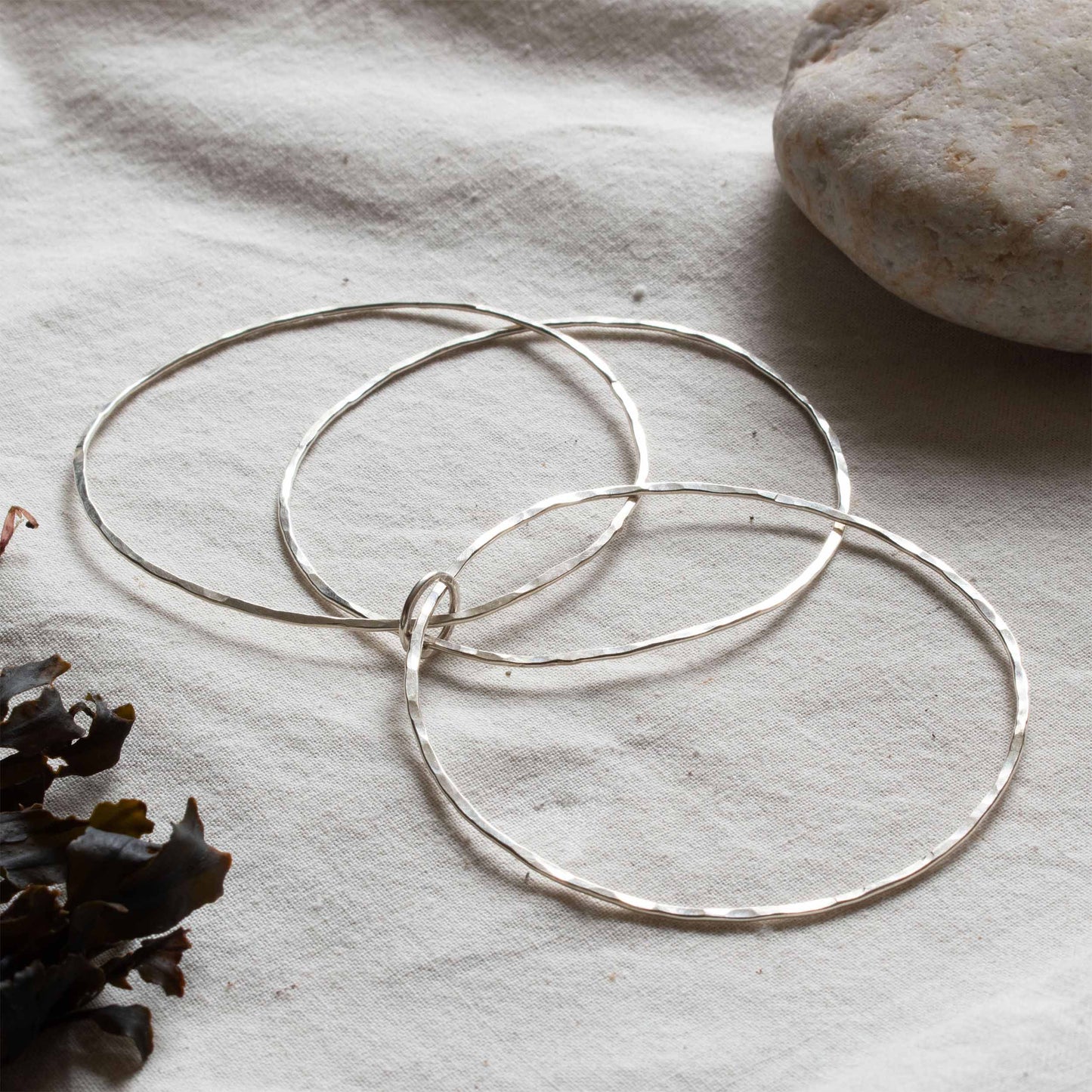 Silver bangle made up of three hoops.