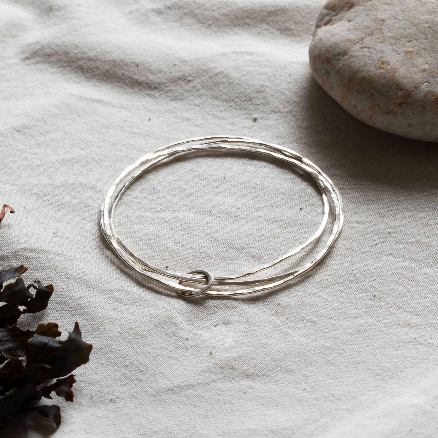 Silver bangle made up of three hoops.