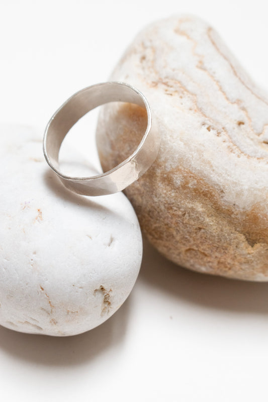 Silver ring on two pebbles