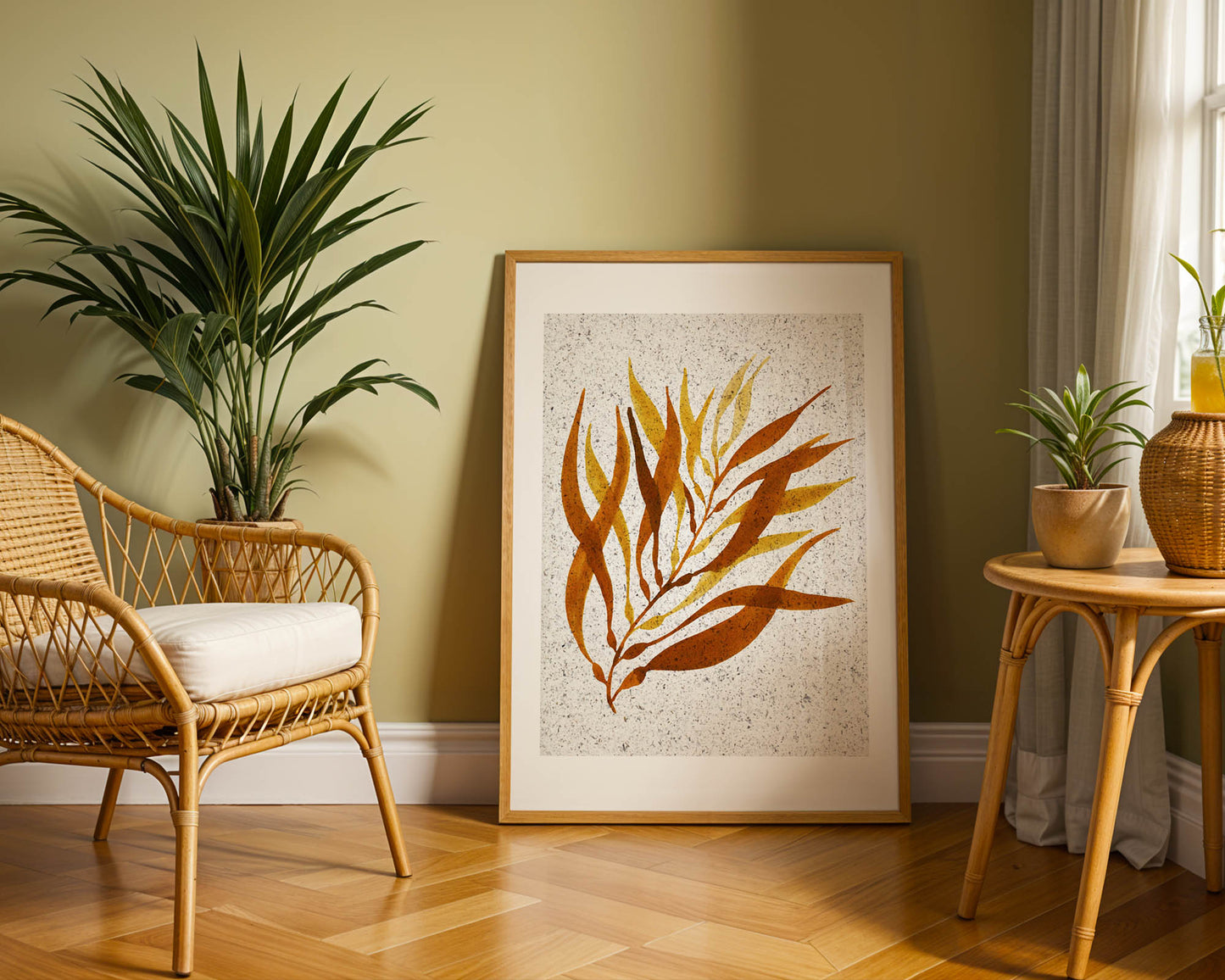 Room interior with a wicker chair, plant, and framed seaweed artwork on a wall.