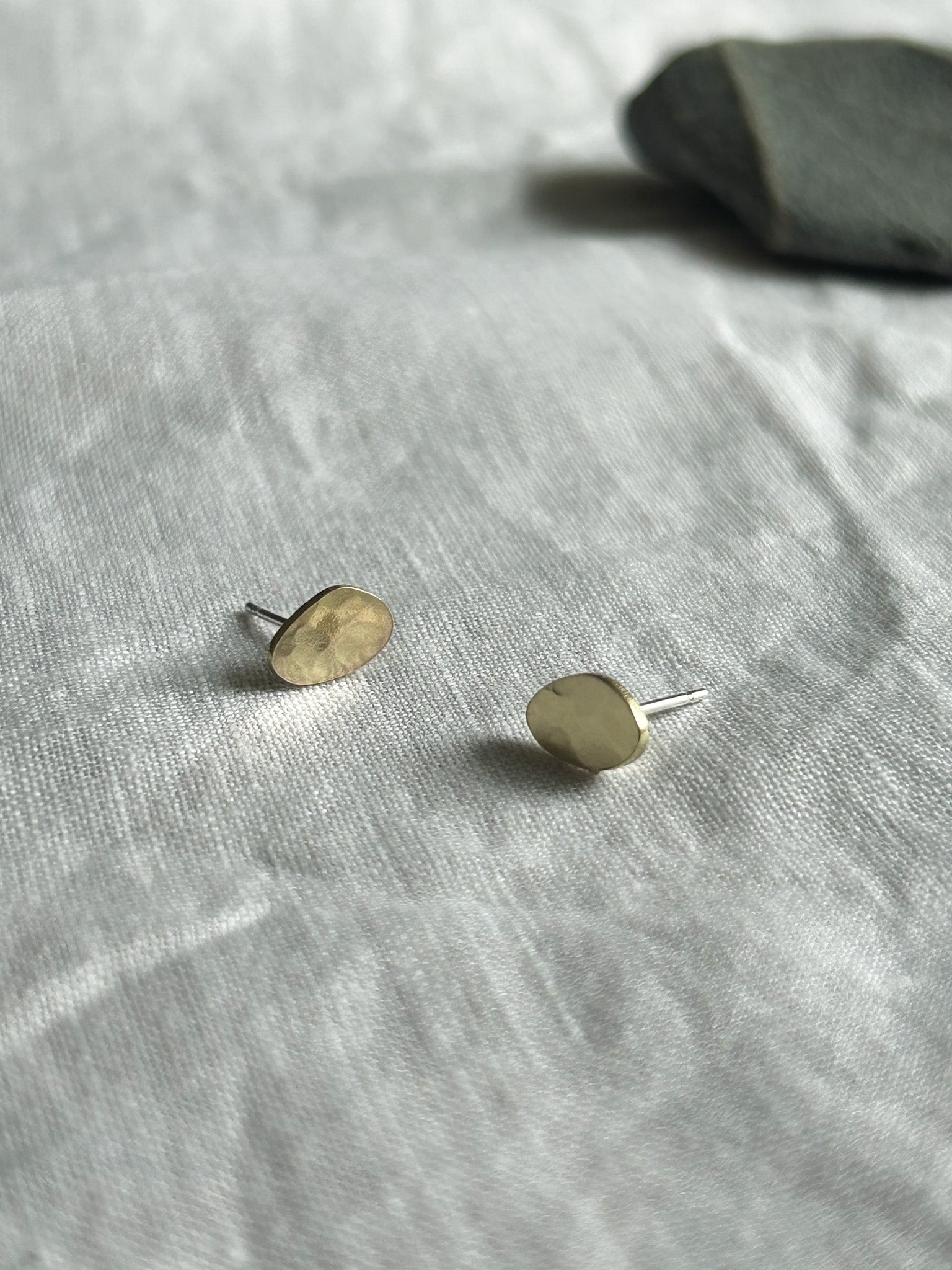 Brass studs on cream linen background