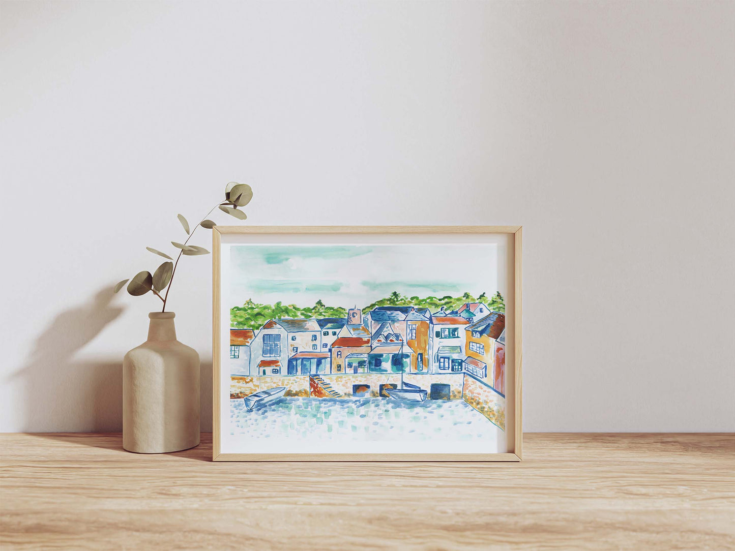 Painting of Padstow, Cornwall, in a A4 frame with a vase next to it. From Kelpi Studio from Cornwall.