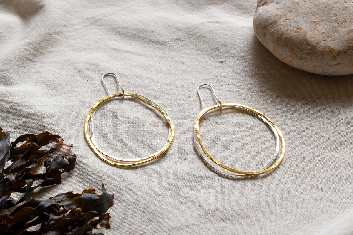 Large hooped dangle earrings made from silver and brass
