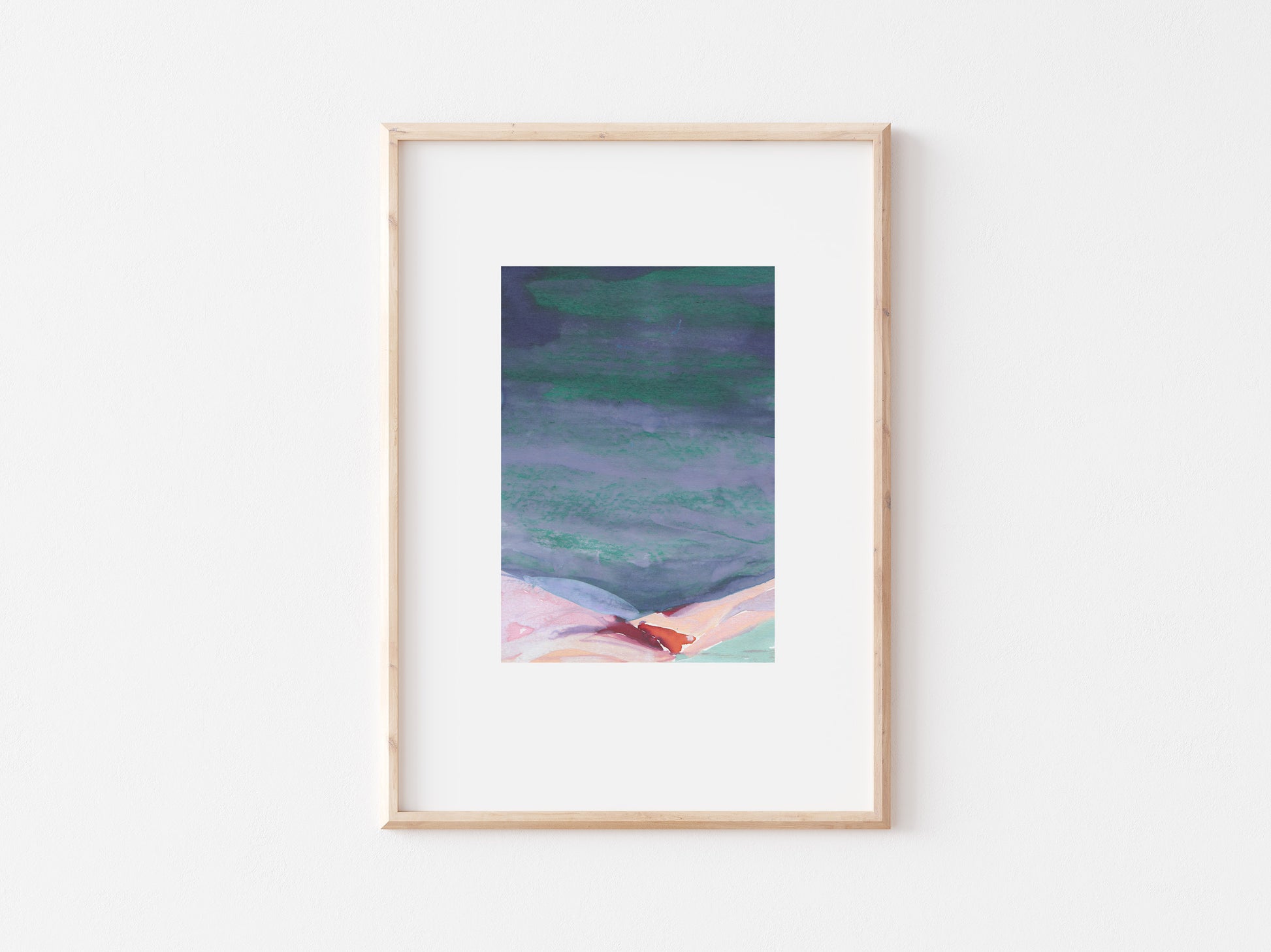 Abstract painting of hills in a wooden frame on a white wall.