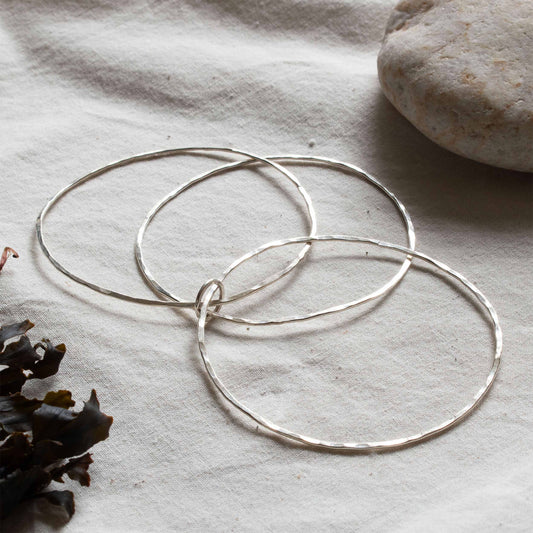 Silver bangle made up of three hoops. 