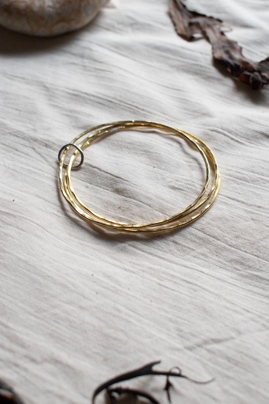 Bangles made from hammered brass hoops. From Kelpi Studio in Cornwall. 