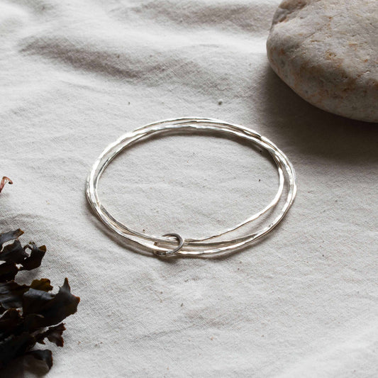 Silver bangle made up of three hoops. 