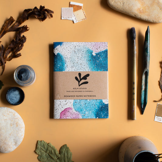 Seaweed notebook with a abstract seaweed design on an artist's table