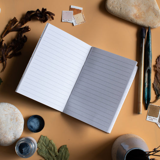 Lined notebook on an artist's table