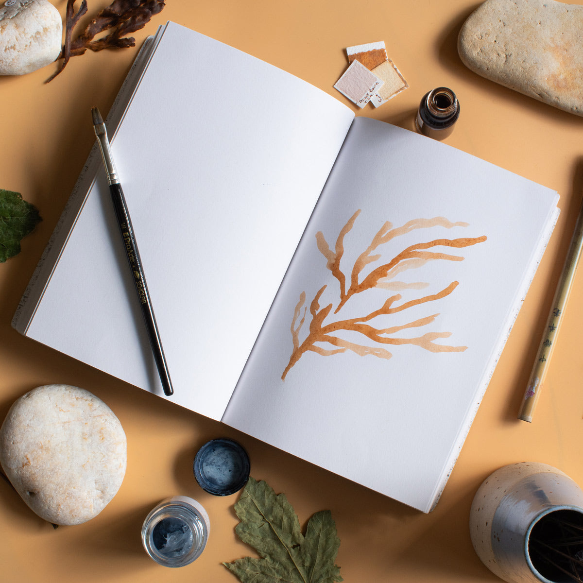Journal with a watercolour design on an artist's table