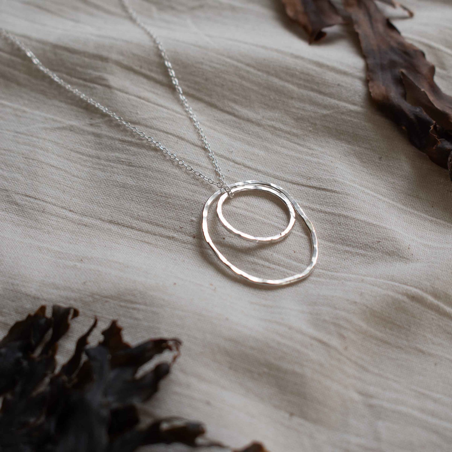 Silver necklace made from two hammered silver hoops