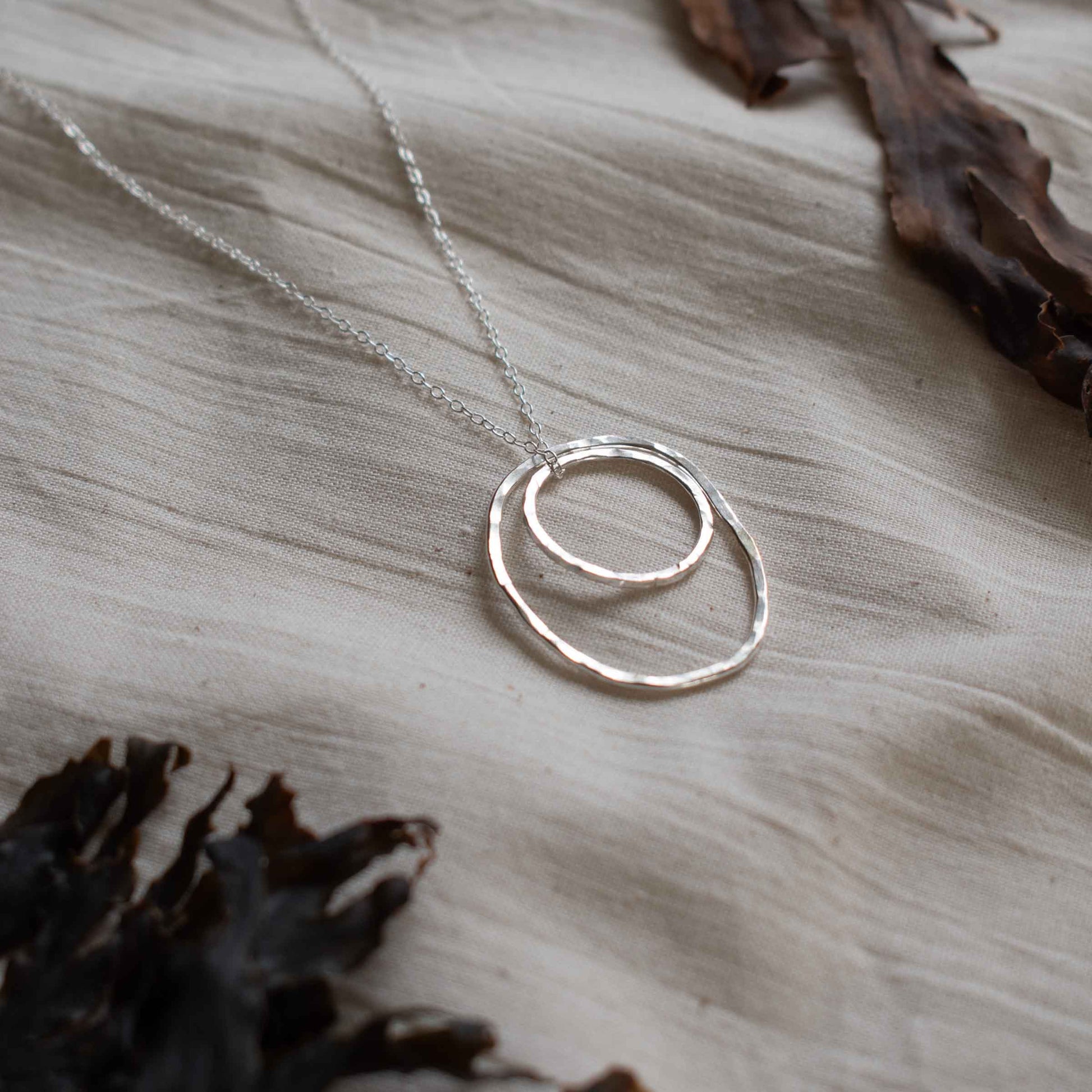 Silver necklace made from two hammered silver hoops