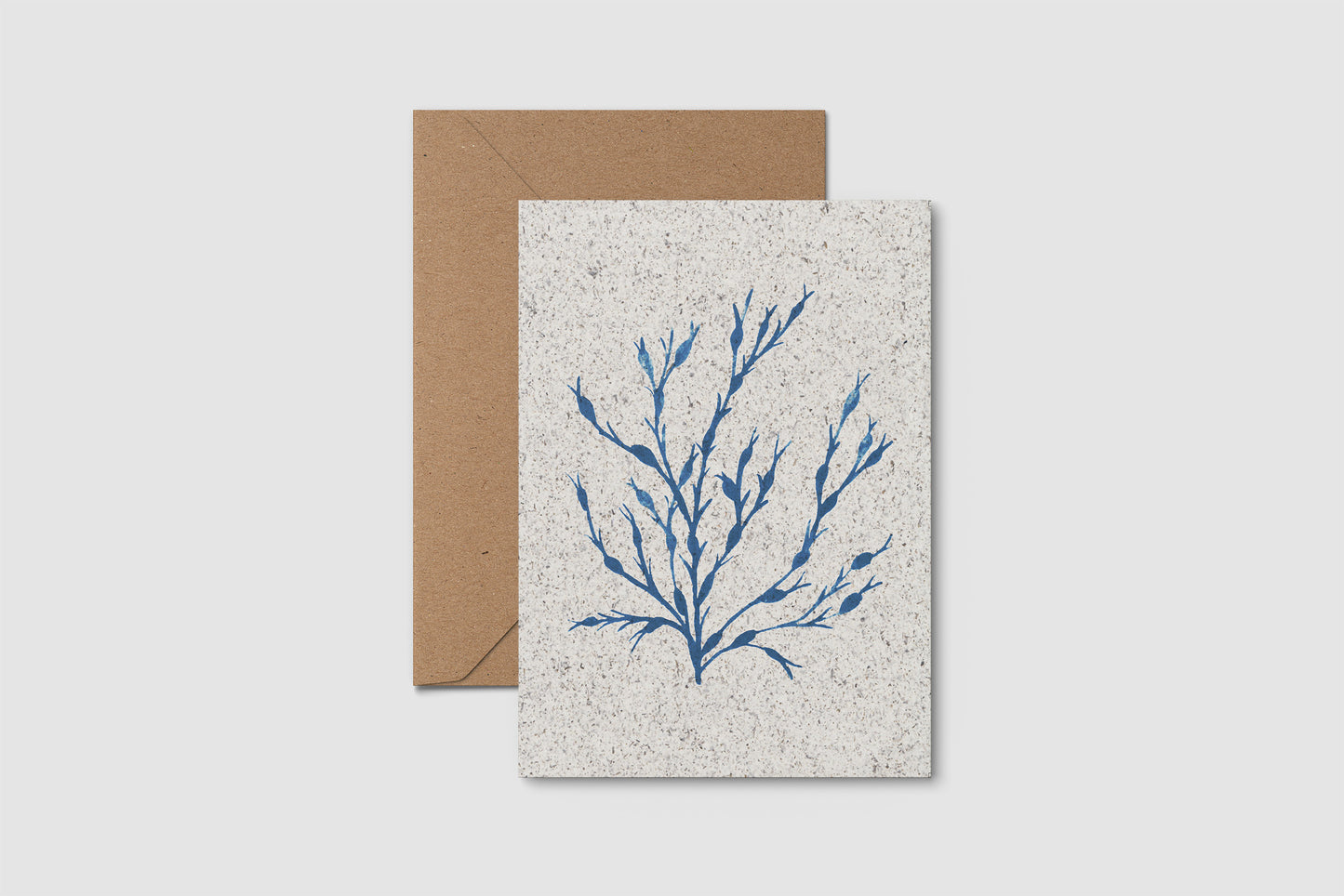 Greeting card with blue seaweed design on textured paper with a brown envelope.