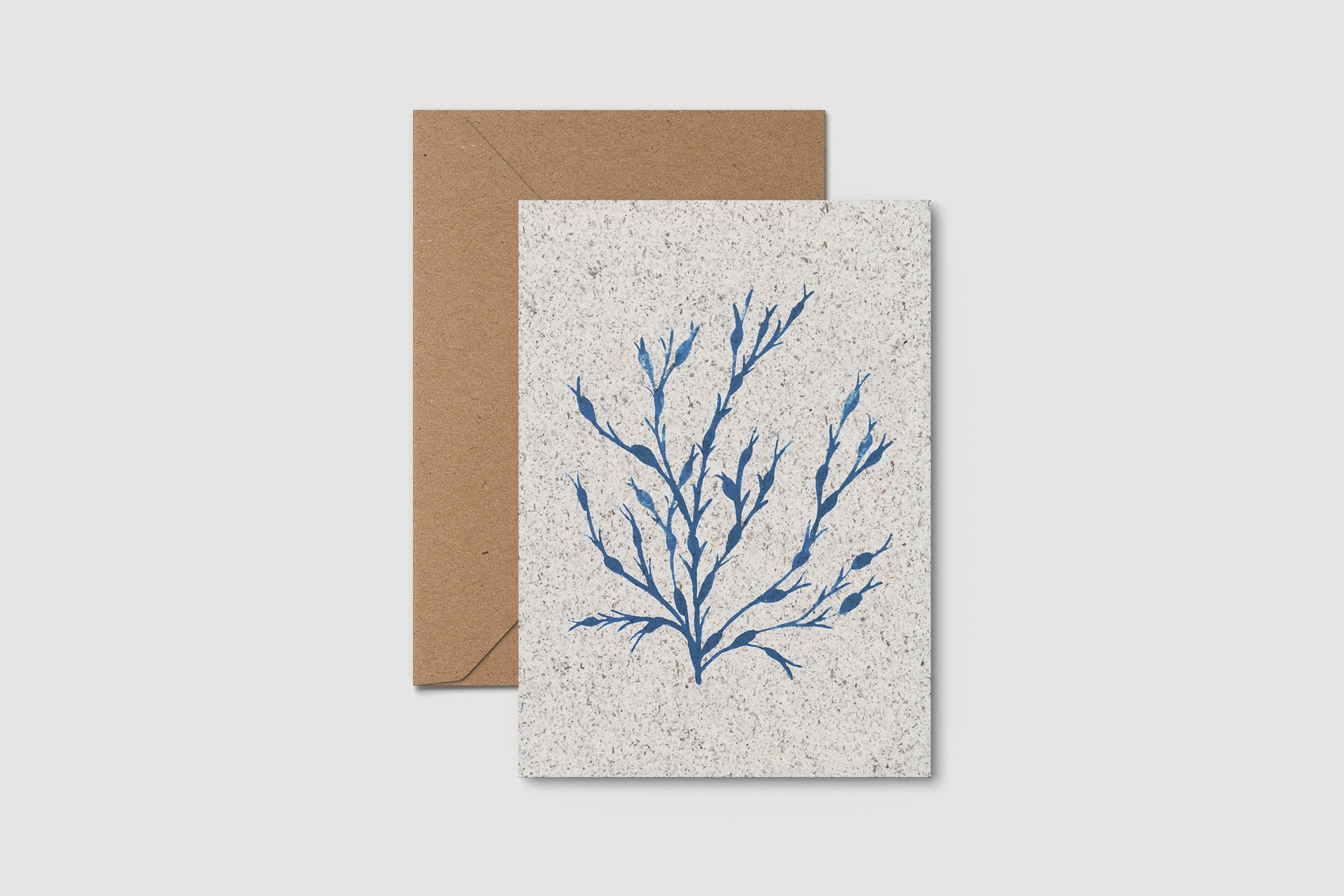 Greeting card with blue seaweed design on textured paper with a brown envelope.