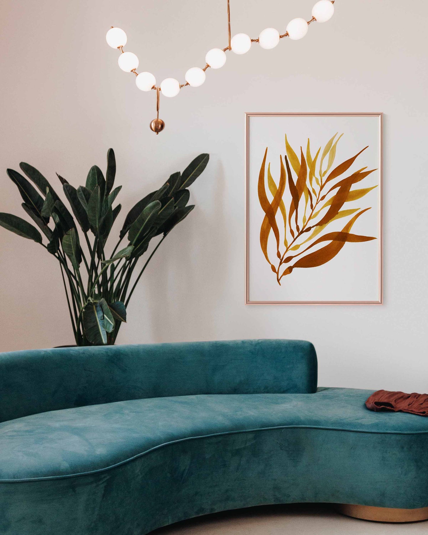 Painted picture of kelp on seaweed paper. The frame is in a lounge. From Kelp Studio in Cornwall. 