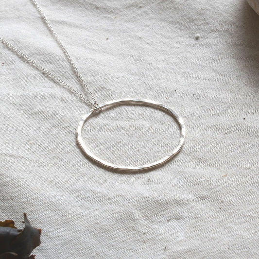 Necklace pendant made from a hammered silver hoop