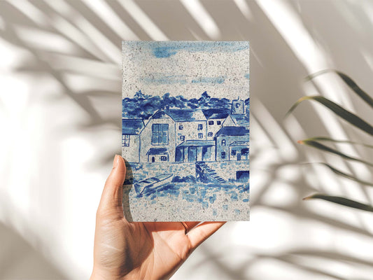 Hand holding a portrait painting Padstow, indigo coloured. On paper made from seaweed. From Kelpi Studio in Cornwall.
