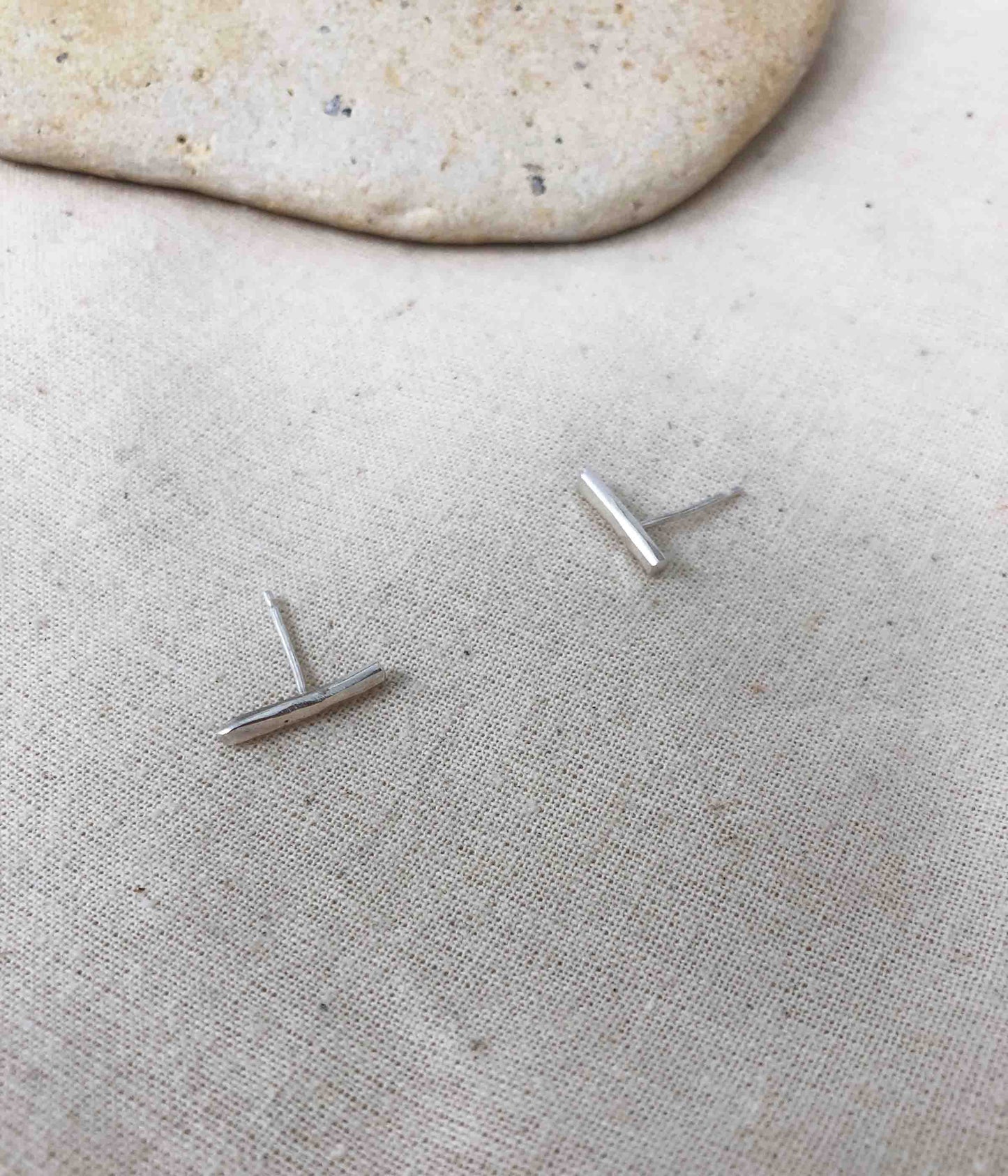 Silver earring studs in the shape of a bar