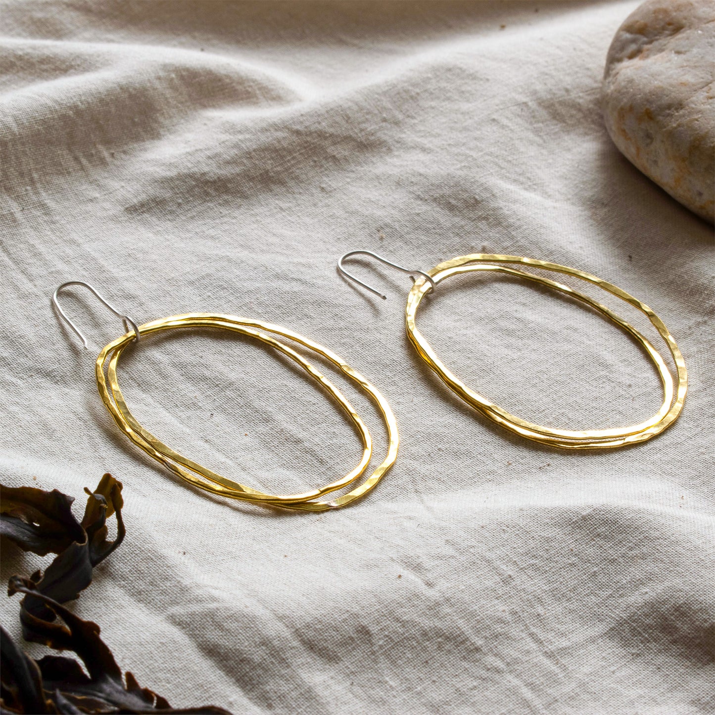 A pair of large brass hooped earrings