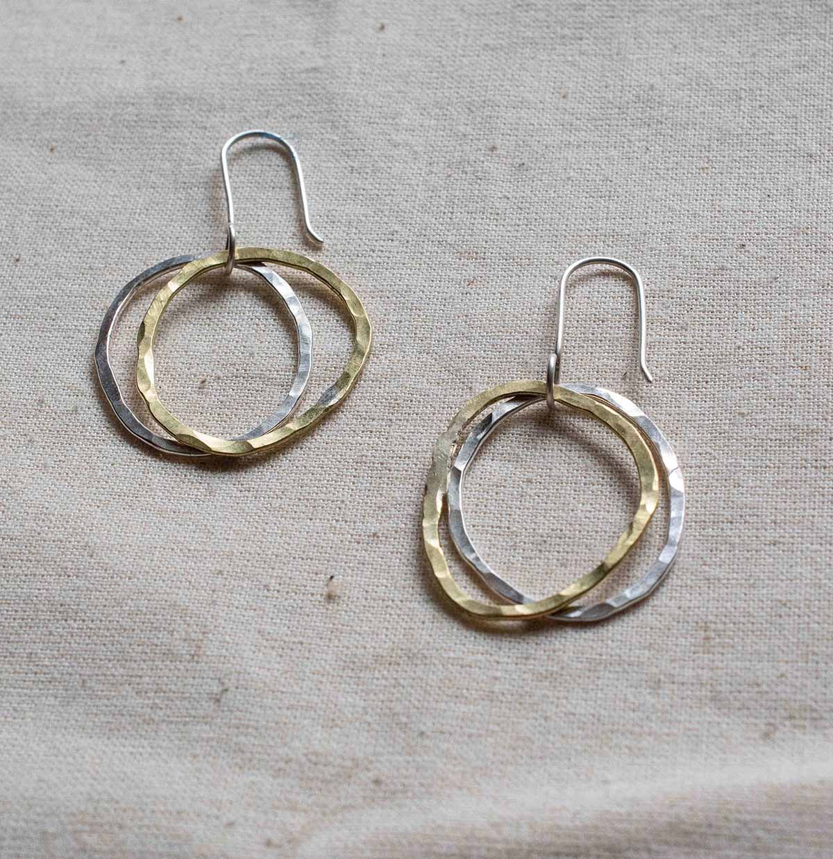 Silver and brass earrings made from hoops.