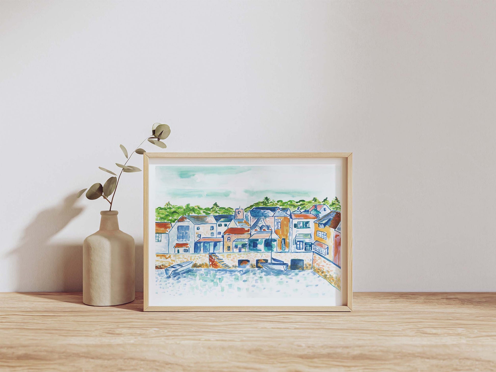 Painting of Padstow, Cornwall, in a A4 frame with a vase next to it. From Kelpi Studio from Cornwall.